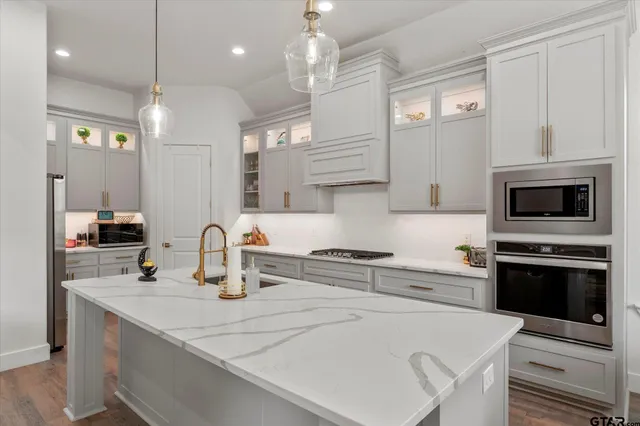 a kitchen with a sink a stove and oven