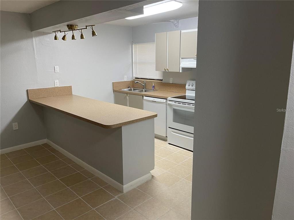 2811 Southwest Archer Road, Unit R144 Gainesville, FL 32608 - Photo 11 of 12 a kitchen with a sink cabinets and appliances