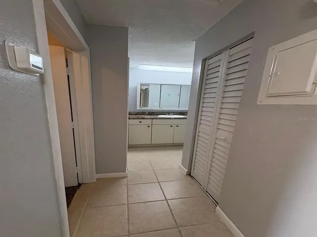 a bathroom with a granite countertop sink and washing machine