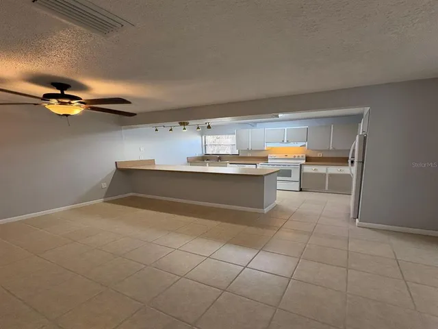 a kitchen with stainless steel appliances a sink and cabinets