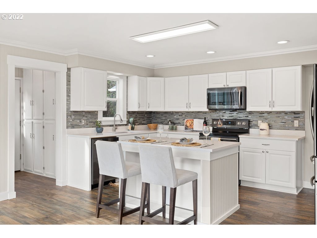 91158 Youngs River Road Astoria, OR 97103 - Photo 11 of 32 a kitchen with kitchen island granite countertop a sink cabinets and stainless steel appliances