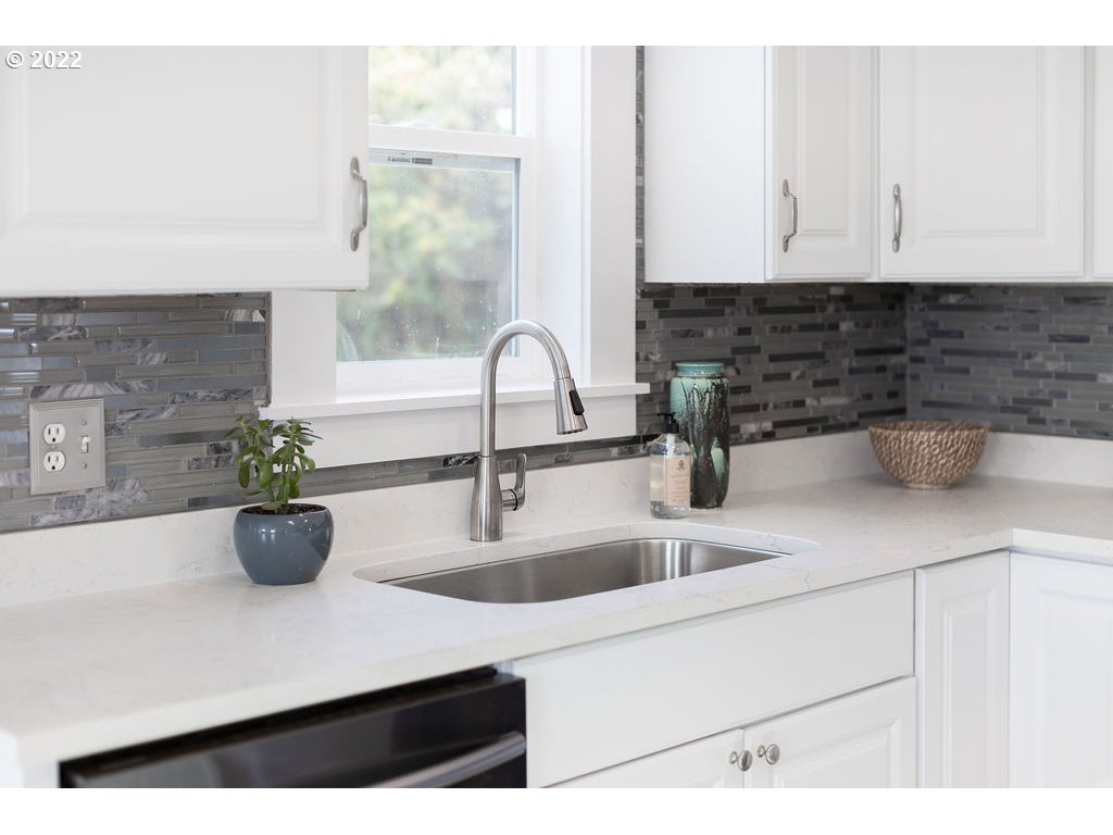 91158 Youngs River Road Astoria, OR 97103 - Photo 13 of 32 a kitchen with a sink and potted plant