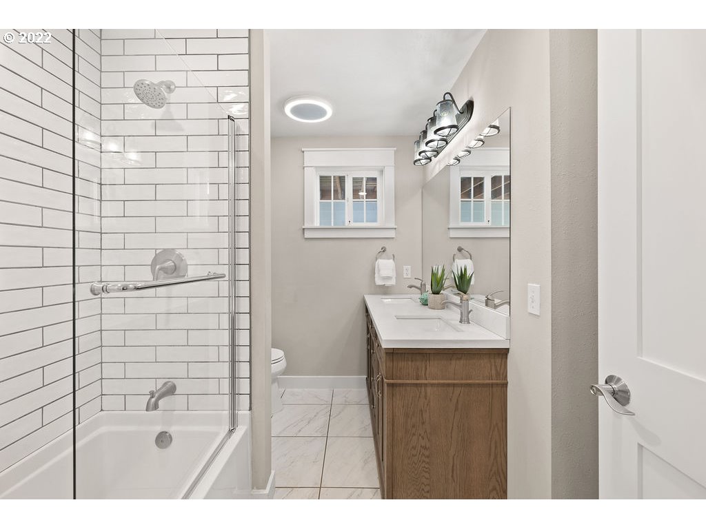 91158 Youngs River Road Astoria, OR 97103 - Photo 18 of 32 a bathroom with a sink a mirror and shower