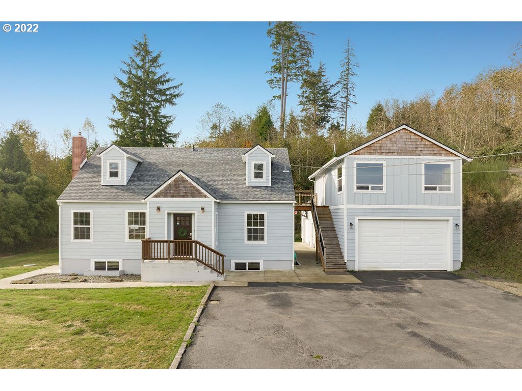 91158 Youngs River Road Astoria, OR 97103 - Photo 2 of 32 a front view of a house with a garden