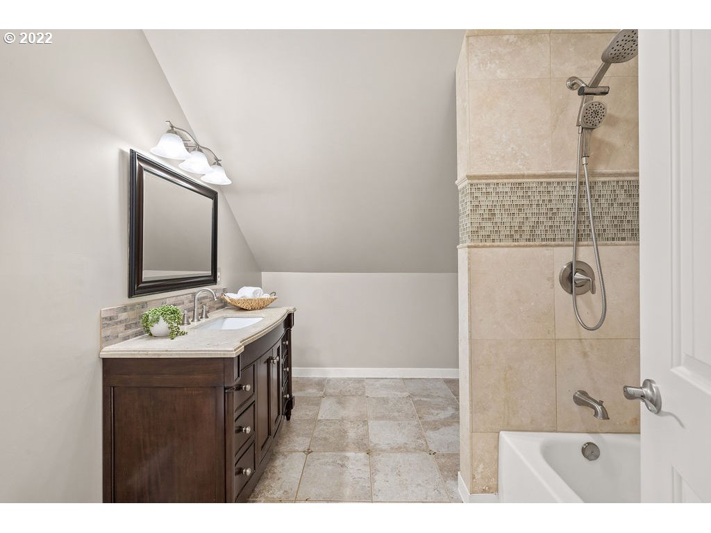 91158 Youngs River Road Astoria, OR 97103 - Photo 23 of 32 a bathroom with a granite countertop sink a mirror and shower