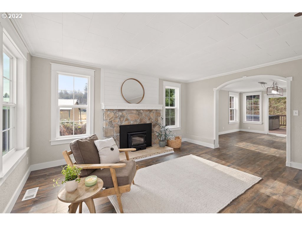 91158 Youngs River Road Astoria, OR 97103 - Photo 7 of 32 a living room with furniture and a fireplace