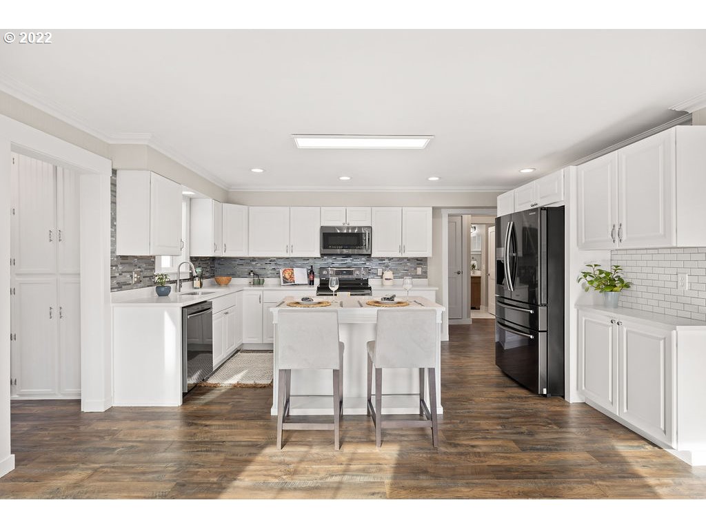 91158 Youngs River Road Astoria, OR 97103 - Photo 9 of 32 a kitchen with white cabinets and stainless steel appliances