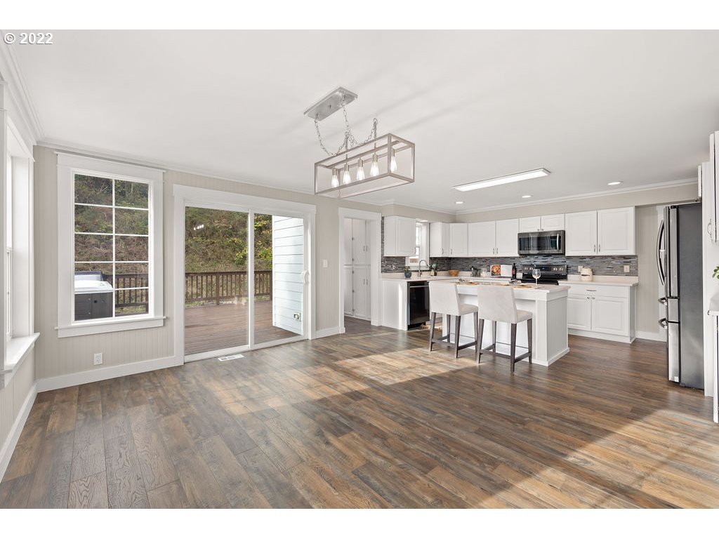91158 Youngs River Road Astoria, OR 97103 - Photo 10 of 32 a view of a kitchen with furniture and wooden floor