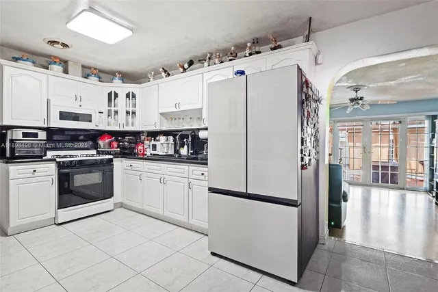 a kitchen with stainless steel appliances a refrigerator sink and cabinets