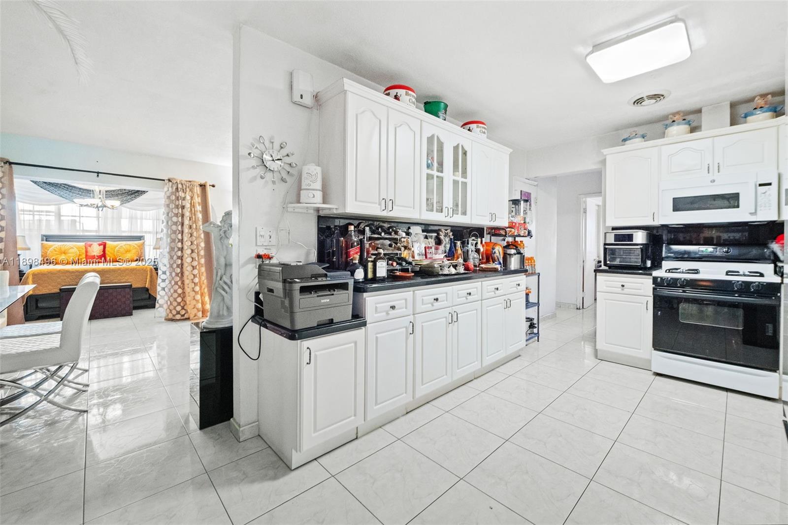 100 East 37th Street Hialeah, FL 33013 - Photo 12 of 25 a kitchen with stainless steel appliances a sink and cabinets