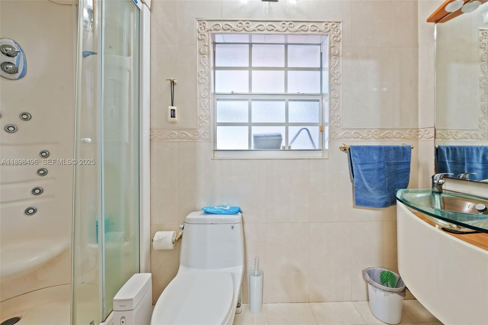 100 East 37th Street Hialeah, FL 33013 - Photo 14 of 25 a bathroom with a granite countertop sink a toilet and shower
