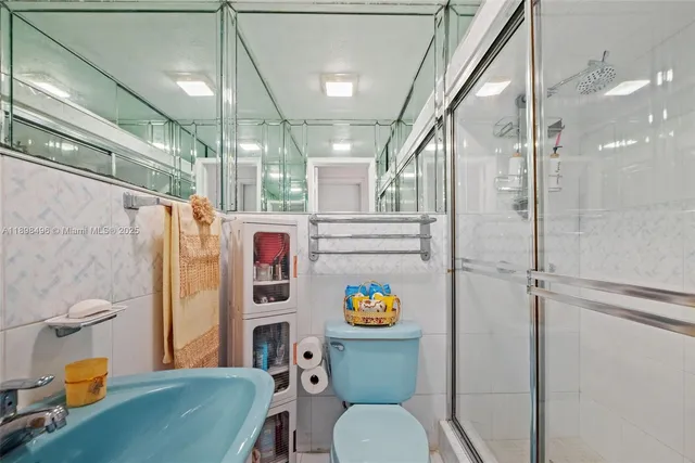 a bathroom with a toilet a sink and shower