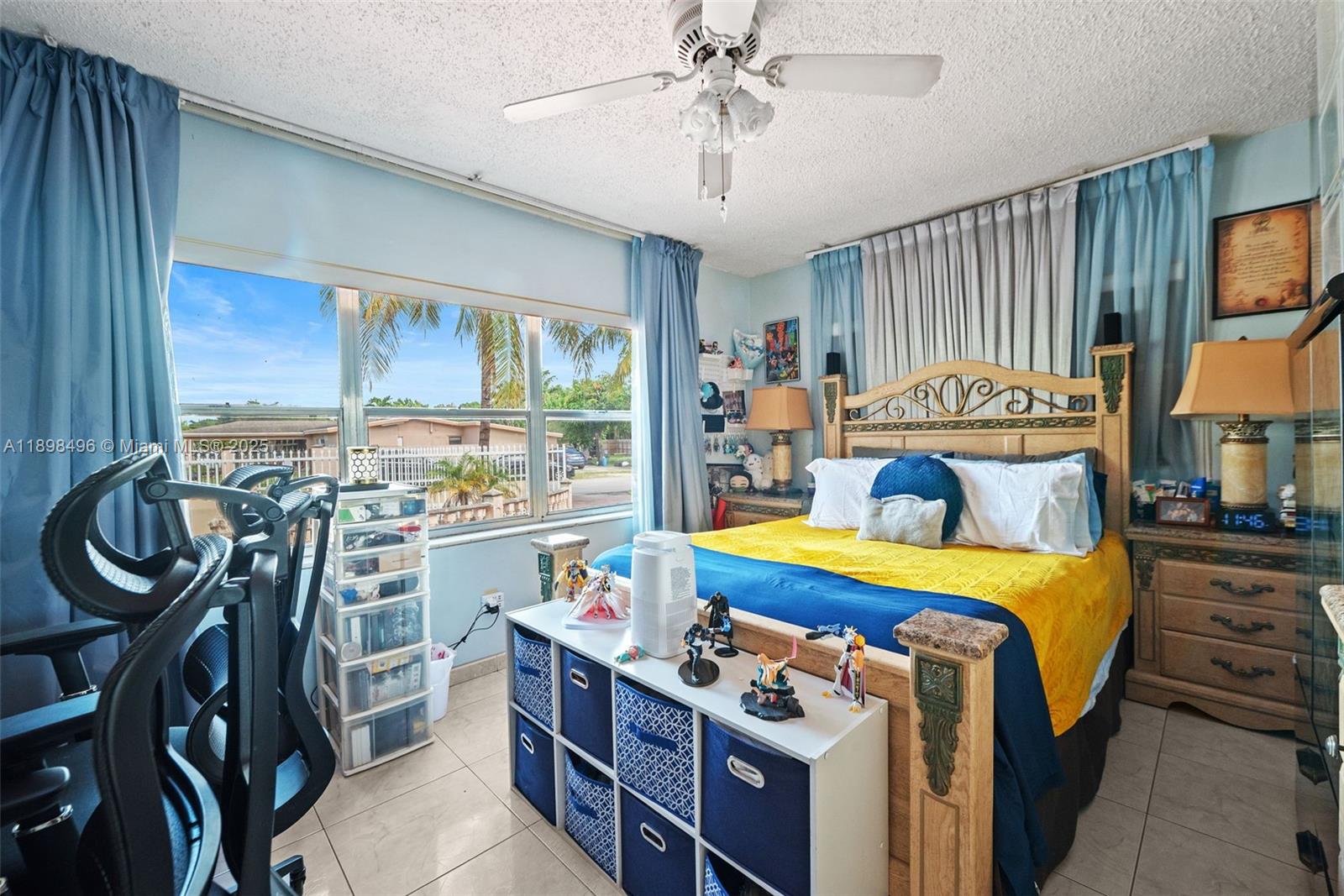 100 East 37th Street Hialeah, FL 33013 - Photo 17 of 25 a bed room with a bed and a chandelier