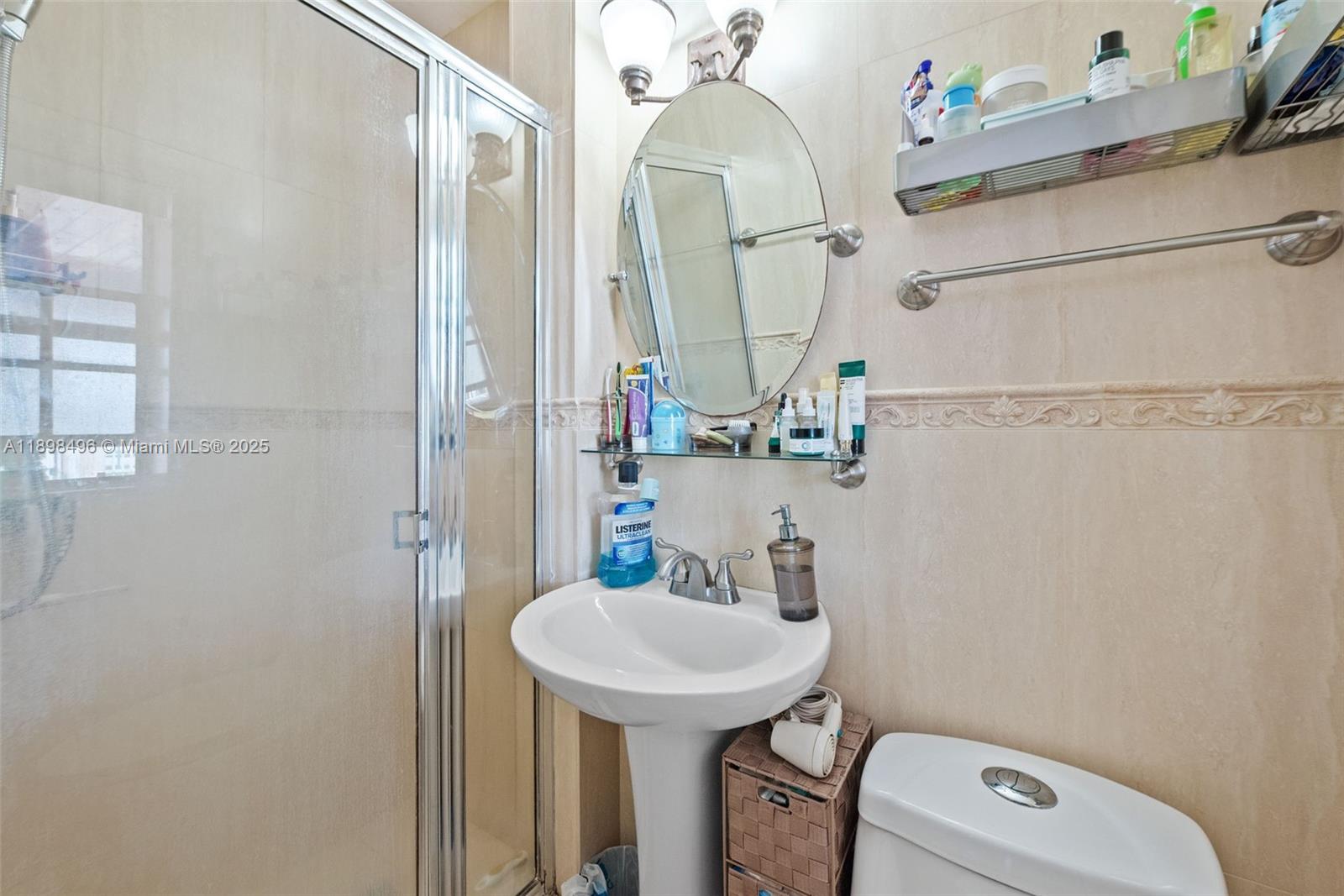 100 East 37th Street Hialeah, FL 33013 - Photo 18 of 25 a bathroom with a sink a mirror and a toilet