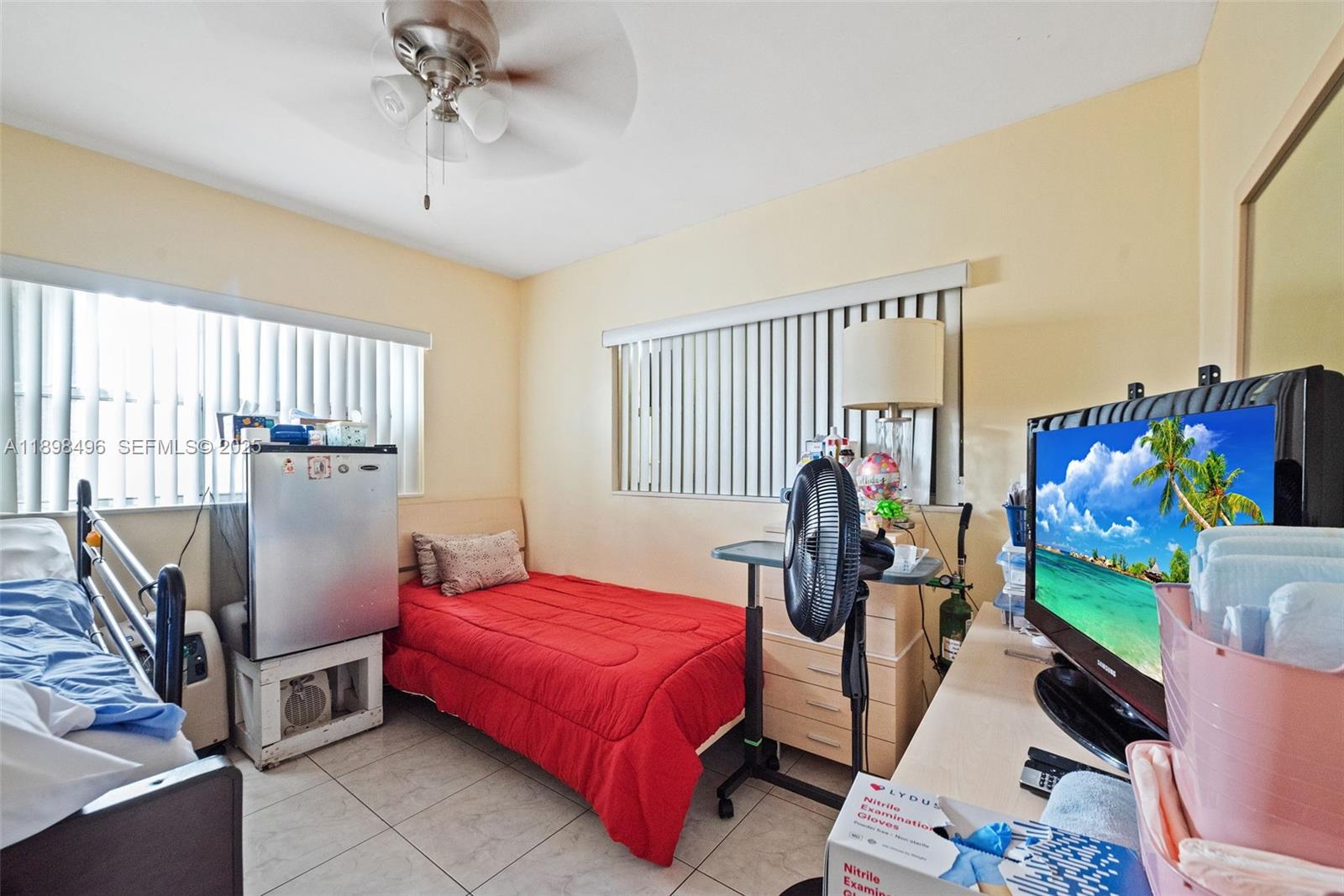 100 East 37th Street Hialeah, FL 33013 - Photo 19 of 25 a bedroom with a bed and wooden floor
