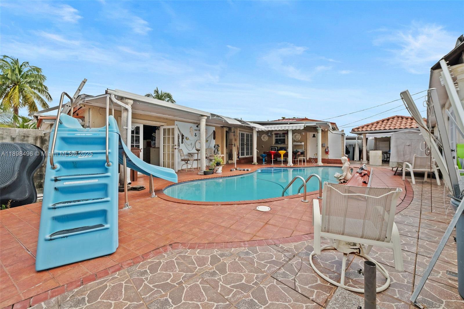 100 East 37th Street Hialeah, FL 33013 - Photo 24 of 25 a front view of a house with a garden and yard