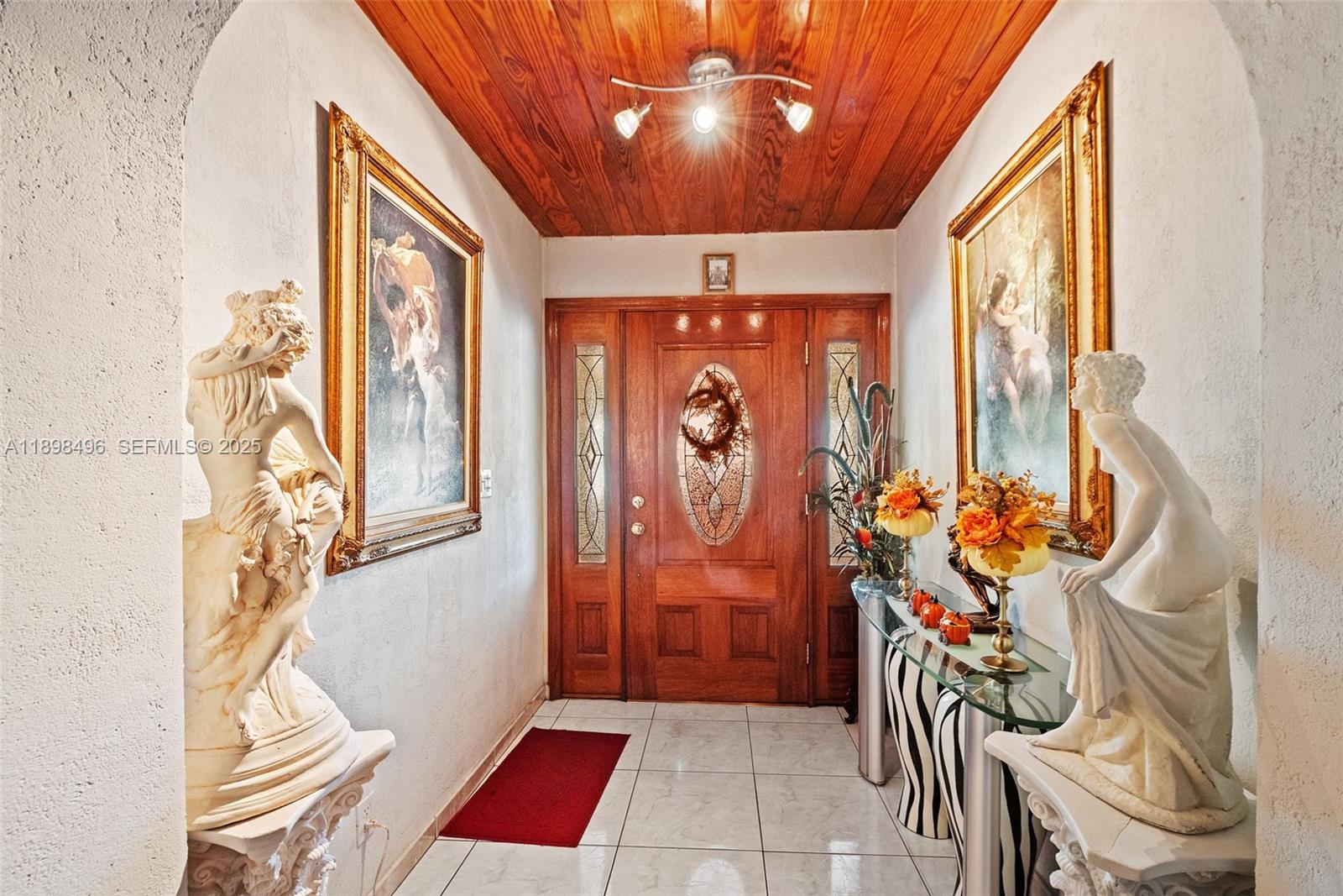 100 East 37th Street Hialeah, FL 33013 - Photo 4 of 25 a view of an entryway with wooden floor and a chandelier
