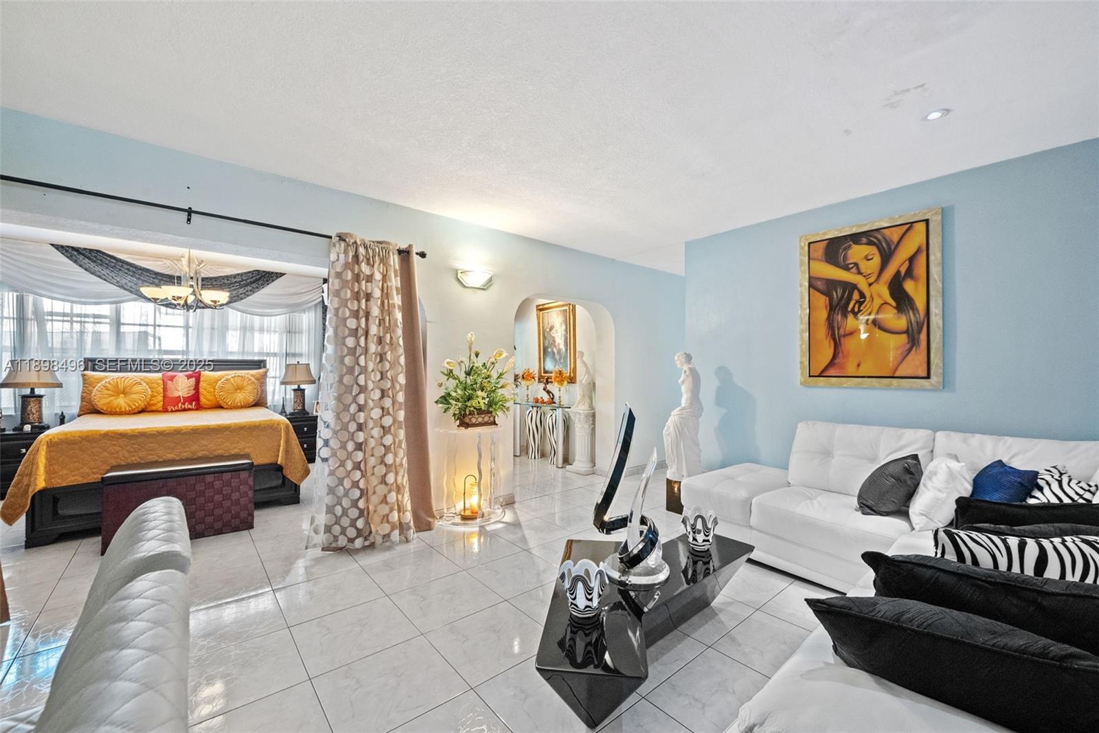 100 East 37th Street Hialeah, FL 33013 - Photo 7 of 25 a bedroom with furniture and a bathtub