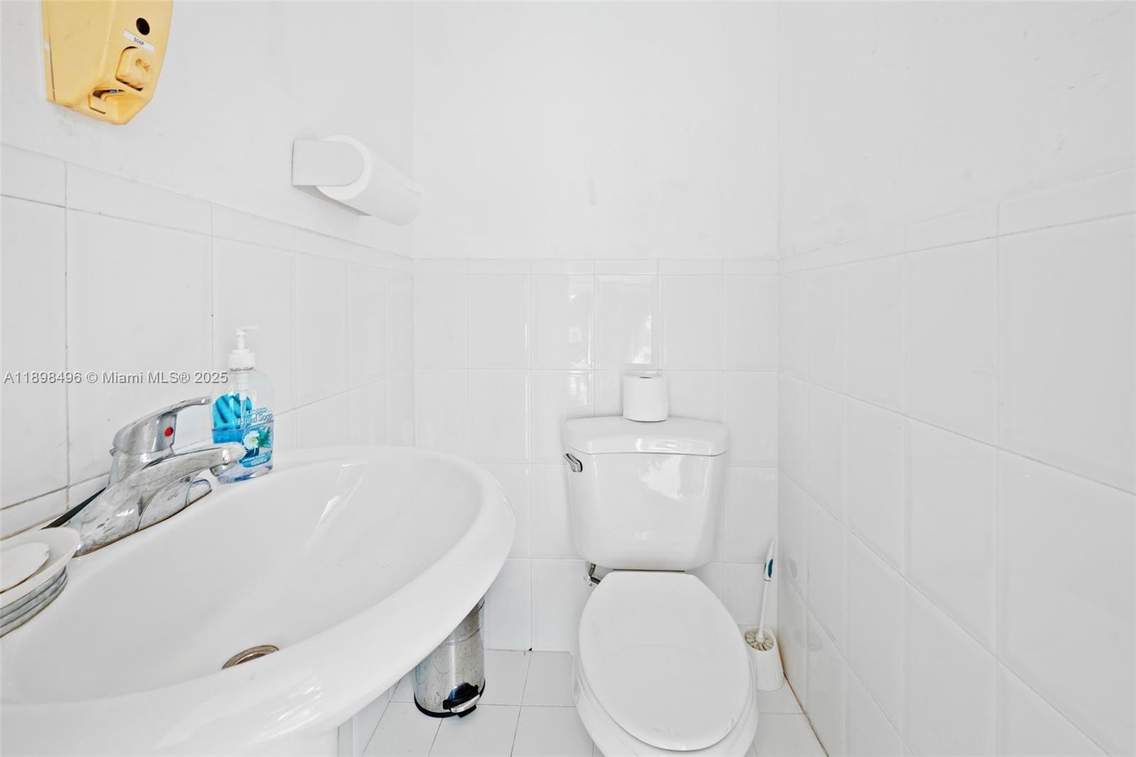 100 East 37th Street Hialeah, FL 33013 - Photo 9 of 25 a white toilet sitting next to a white sink