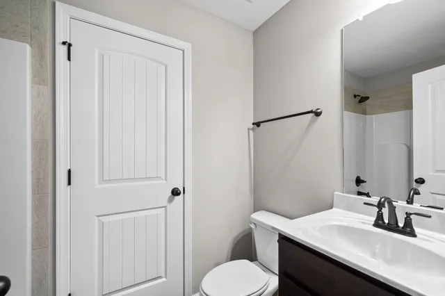 a bathroom with a sink toilet and vanity