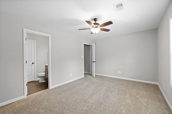 a view of an empty room and a bathroom