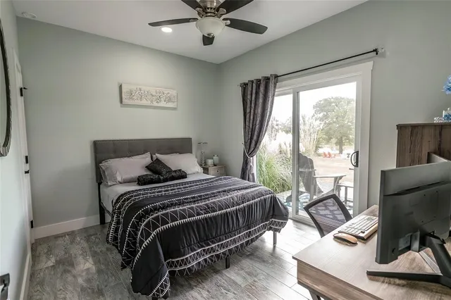 a bedroom with a bed and glass door