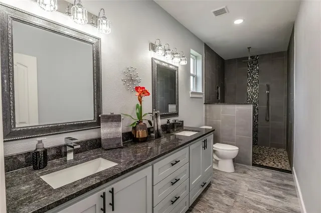 a bathroom with 2 sink and a mirror