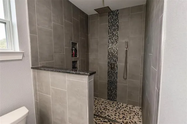 a bathroom with a shower and a sink