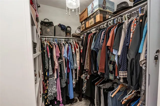 a view of walk in closet with clothes