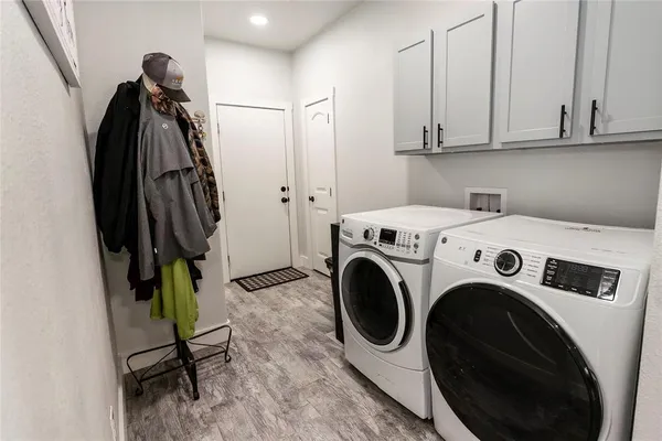 a utility room with sink dryer and washer