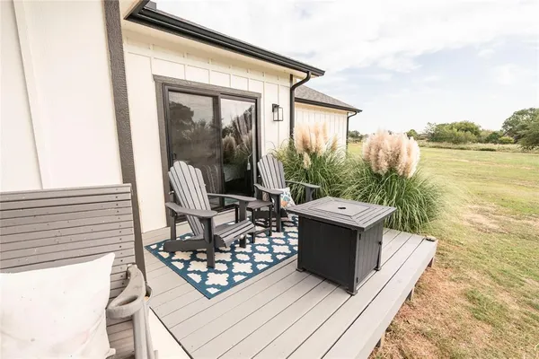 a kitchen with kitchen island a sink stove a refrigerator and white cabinets with wooden floor