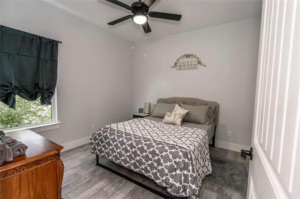 140 Lago Lane Nocona, TX 76255 - Photo 29 of 39 a bedroom with a bed and a flat screen tv