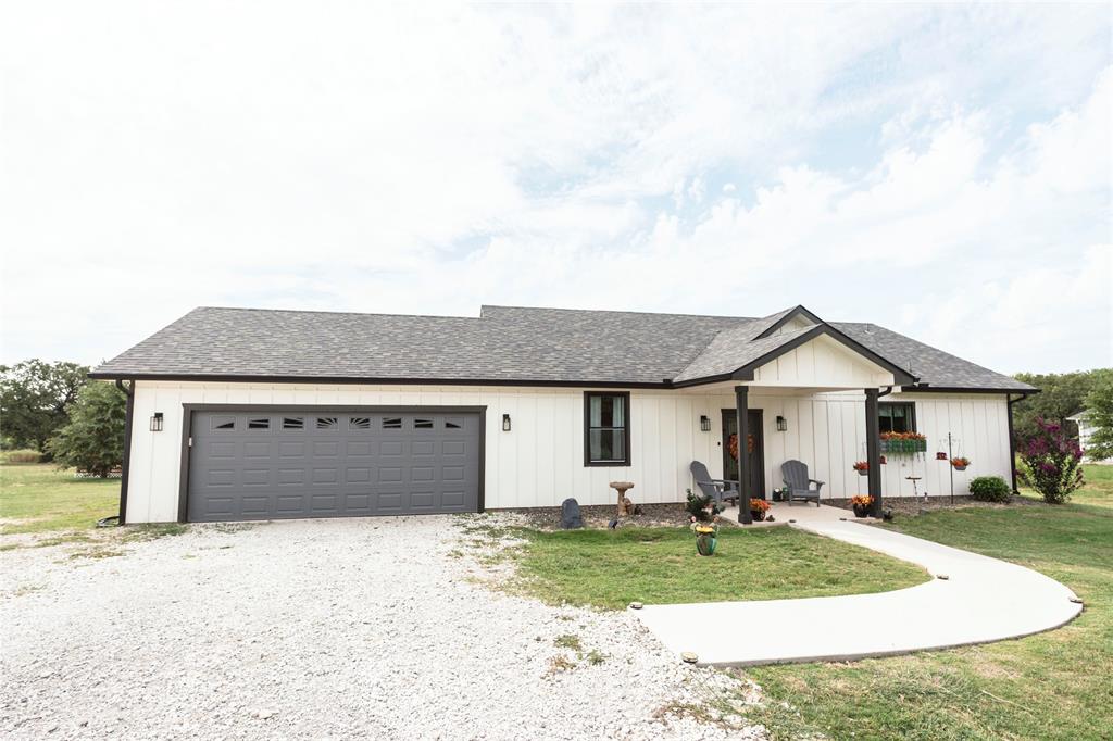140 Lago Lane Nocona, TX 76255 - Photo 39 of 39 a front view of a house with a yard and garage