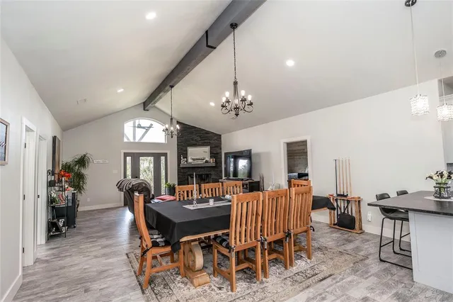a view of a a dining room with furniture window and wooden floor