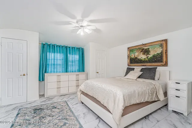 a bedroom with a bed and a painting on the wall