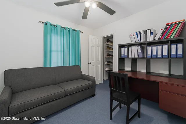 a living room with furniture and a book shelf