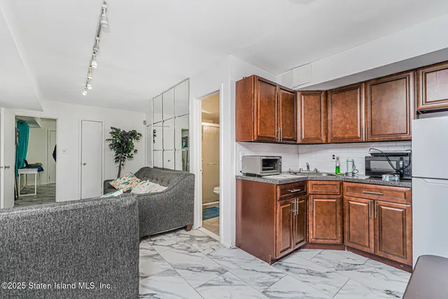 a kitchen with stainless steel appliances granite countertop a stove a sink dishwasher and cabinets