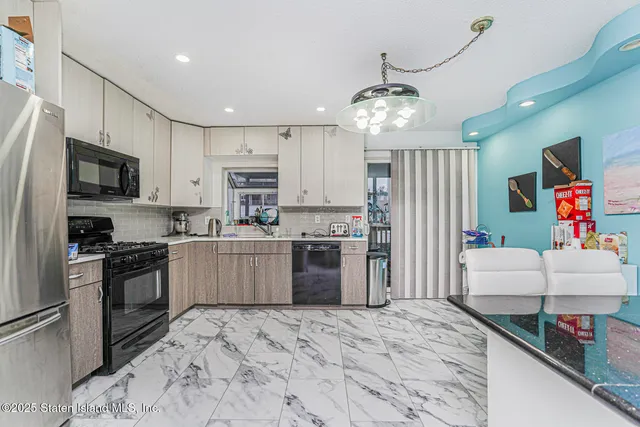 a kitchen with granite countertop a refrigerator oven a sink and dishwasher