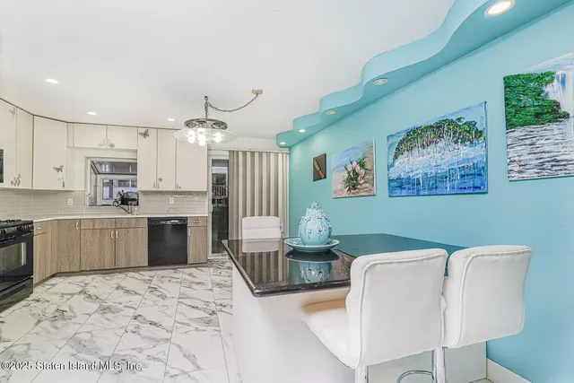 a living room with furniture and kitchen view