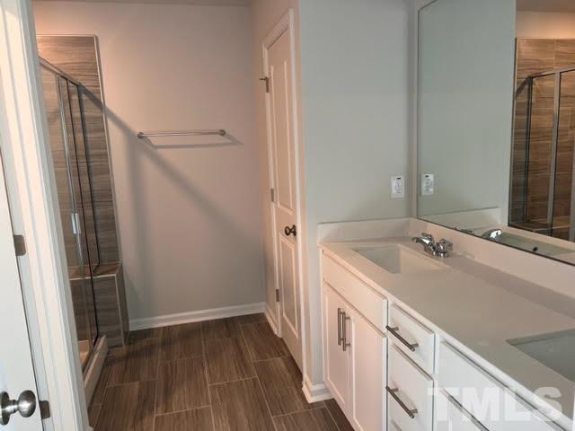 2403 Chert Lane, Unit 2403 Raleigh, NC 27610 - Photo 15 of 19 a bathroom with a sink and mirror