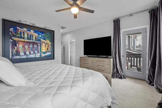 a spacious bedroom with a large bed and a chandelier