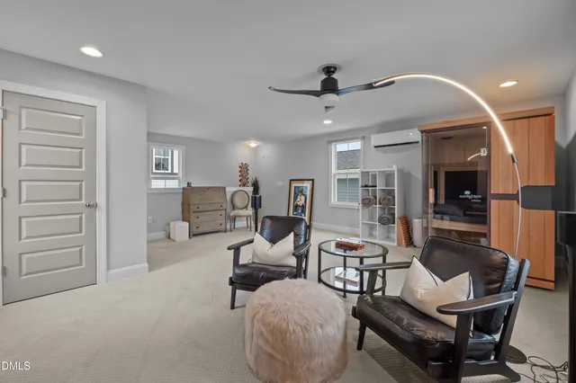 a view of a livingroom with furniture and a flat screen tv