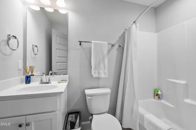a living room with furniture and a ceiling fan