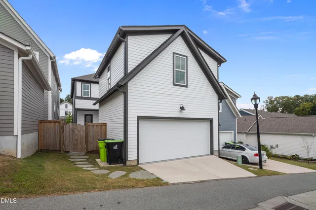 a view of a patio with couches chairs potted plants and wooden floor