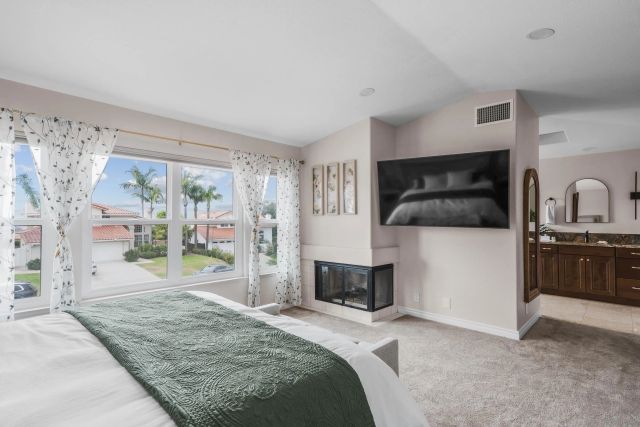 a bedroom with a bed and a television in it