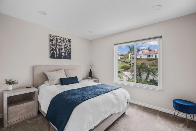 a bedroom with a bed and a painting on the wall