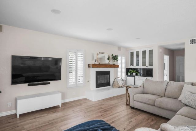 a living room with fireplace furniture and a flat screen tv