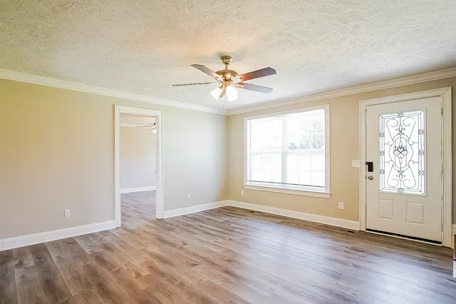 wooden floor in an empty room with a window