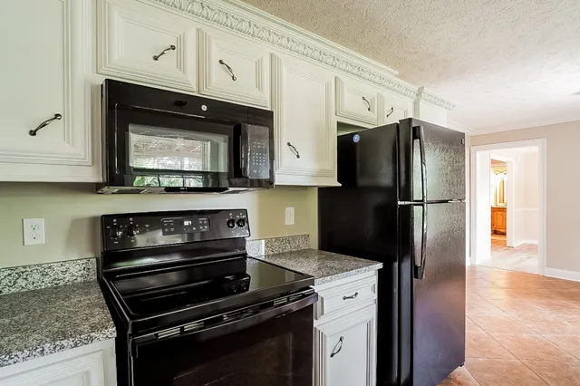 a kitchen with a refrigerator stove and microwave