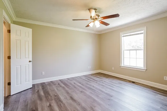 wooden floor in an empty room with a window